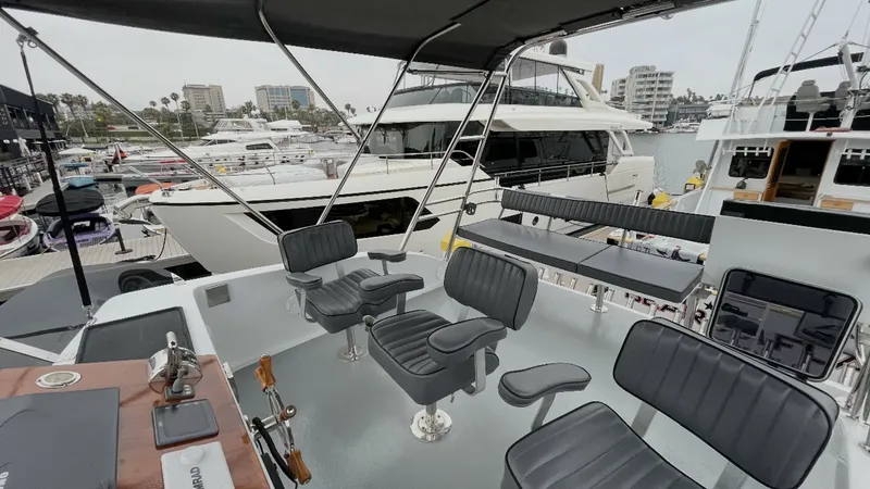 Slide: The Image of Spacious Flybridge Seating Area The flybridge of the 2019 Donelle 36 Flybridge Sportfish offers a spacious layout with multiple cushioned swivel chairs, perfect for enjoying panoramic views while cruising. The helm station is equipped with essential controls, providing convenience and f - 7398004