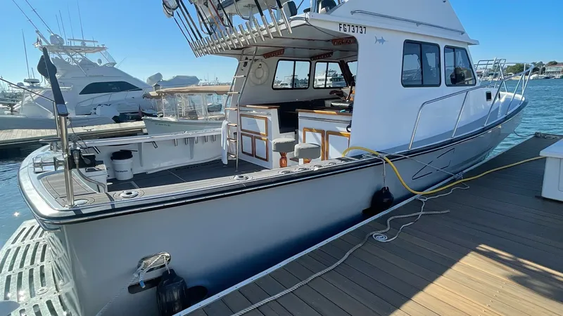 Slide: The Image of Spacious Aft Deck and Flybridge The BEAR FLAG III boasts a generous aft deck perfect for fishing or entertaining, complemented by a sturdy flybridge for elevated views. The well-equipped deck features ample seating and storage, making it ideal for sportfishing enthusiasts. The sleek, mo - 7398011