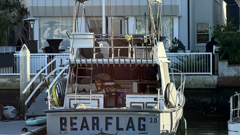 Slide: The Image of Aft View of Flybridge Sportfish This image showcases the aft view of the 2019 Donelle 36 Flybridge Sportfish, 'BEAR FLAG III'. The vessel's spacious cockpit is designed for sportfishing, with ample storage and seating. The flybridge offers excellent visibility, perfect for navigating an - 7398006