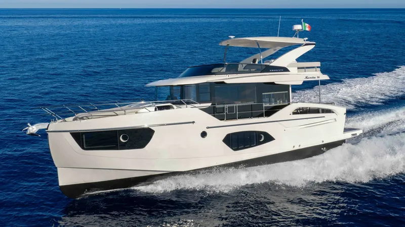 The Image of Side Profile of Navetta 50 Underway The 2027 Absolute Navetta 50 is captured cruising elegantly on open waters, showcasing its sleek, modern design. The spacious flybridge and expansive windows highlight the vessel's luxurious features, offering panoramic views and ample natural light. Its - 7514451