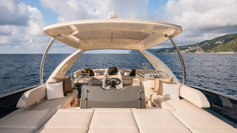 Slide: The Image of Spacious Flybridge Lounge Area The flybridge of the 2027 Absolute Navetta 50 offers a luxurious open-air lounge space with ample cushioned seating, perfect for relaxation and socializing. A sleek hardtop provides shade while allowing panoramic views of the surrounding seascape. Elegant - 7514466