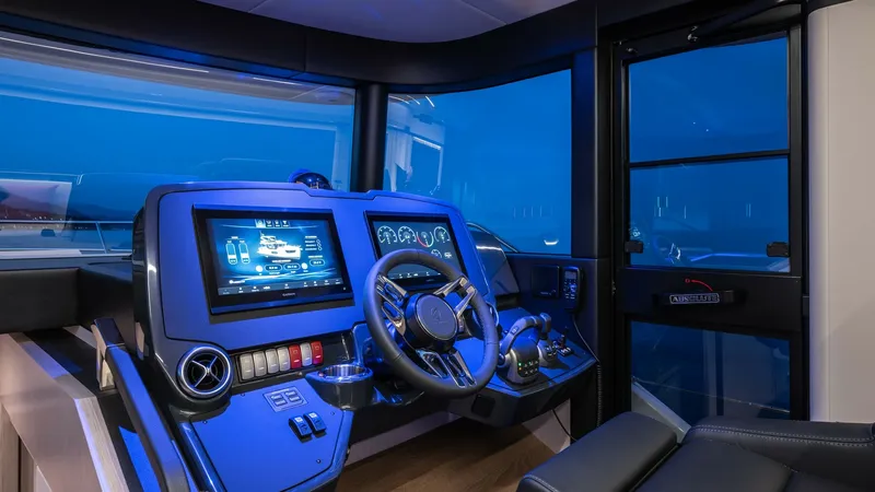 Slide: The Image of Modern Helm Station The helm station of the 2027 Absolute Navetta 50 boasts cutting-edge technology and sleek design. Featuring a state-of-the-art navigation display and intuitive controls, it offers a commanding view through expansive windows. The ergonomic captain's chair - 7514480