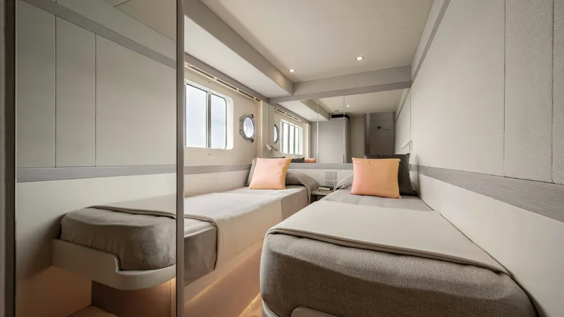 Slide: The Image of Twin Guest Stateroom This elegantly designed twin guest stateroom on the 2027 Absolute Navetta 50 offers a spacious and inviting atmosphere. The room features two comfortable single beds, complemented by soft lighting and modern finishes. Large windows provide ample natural l - 7514476