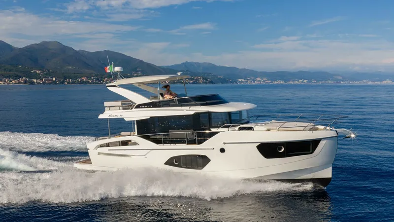 Slide: The Image of Side Profile in Motion This image showcases the sleek side profile of the 2027 Absolute Navetta 50 gliding effortlessly through the water. The yacht's modern design features expansive windows, providing ample natural light and stunning views. Its distinctive hull and elegant li - 7514487