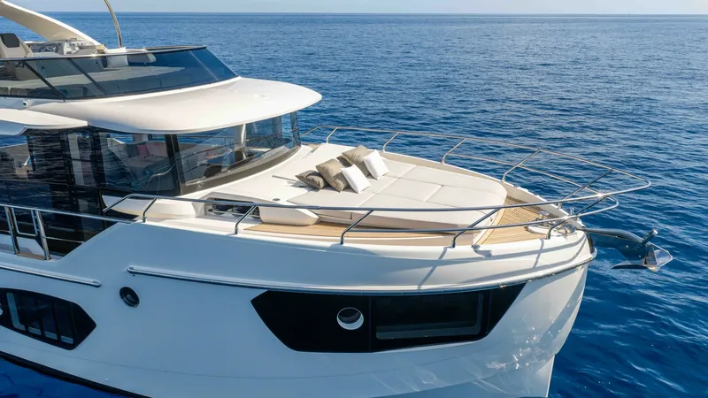 Slide: The Image of Bow Lounge with Sunpads The bow of the 2027 Absolute Navetta 50 features a spacious sun lounge with plush sunpads, perfect for relaxation. The sleek design is complemented by stainless steel railings and expansive windows, offering panoramic ocean views. This inviting space comb - 7514465