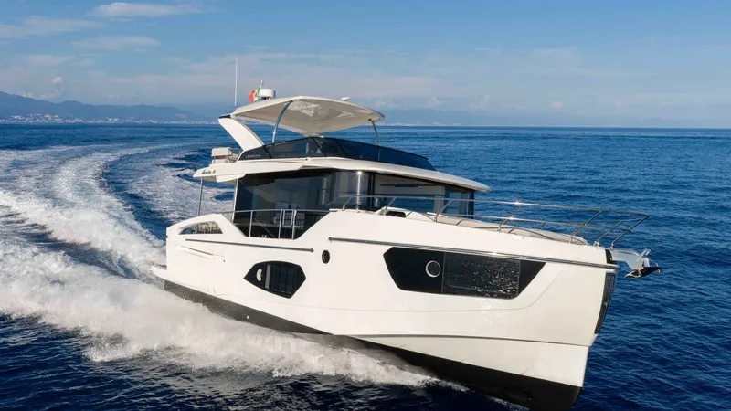 Slide: The Image of Dynamic Forward View Underway The 2027 Absolute Navetta 50 is showcased slicing through the waves, highlighting its sleek, modern design and robust performance. The elegant lines of the hull, combined with large, panoramic windows, offer a perfect blend of style and functionality. The - 7514486