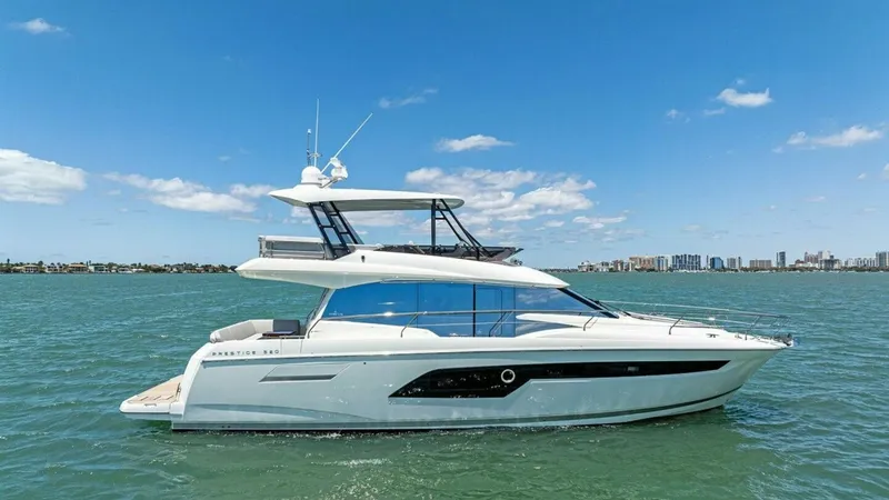 The Image of Profile View of 2024 Prestige 520 Flybridge This image showcases the sleek profile of the 2024 Prestige 520 Flybridge, highlighting its modern design and elegant lines. The spacious flybridge offers ample seating and a commanding view, perfect for navigating in style. With its contemporary windows - 7455376