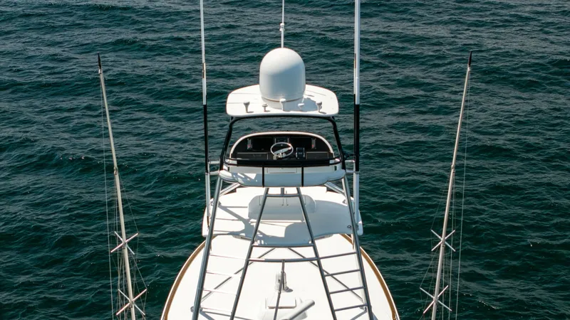 Slide: The Image of Flybridge and Tower View This image showcases the elevated flybridge of the 2025 Viking 74 Convertible, offering an impressive vantage point. The tower is equipped with advanced navigation and communication instruments, ensuring optimal control while at sea. The sleek design and - 7531205