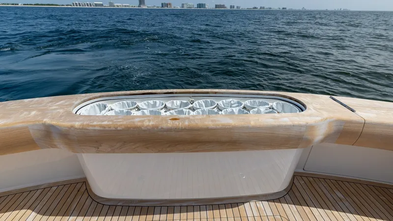 Slide: The Image of Teak Cockpit with Live Bait Well The cockpit of the 2025 Viking 74 Convertible features elegant teak decking and a built-in live bait well, ideal for avid anglers. The spacious area provides ample room for fishing activities, while the high-quality finishes ensure durability and style. E - 7531192