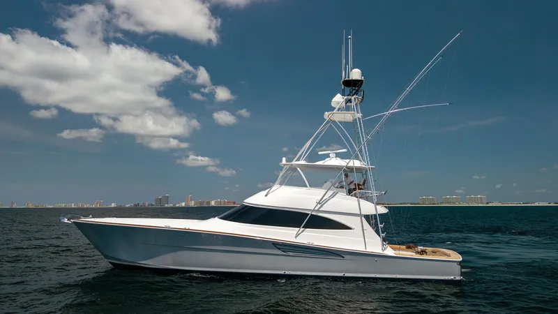 Slide: The Image of Profile in Open Waters The Viking 74 Convertible showcases its sleek and powerful profile as it glides effortlessly through open waters. The vessel's modern design features a striking flybridge and a well-equipped tower for optimal visibility and control. Its refined lines and - 7531209
