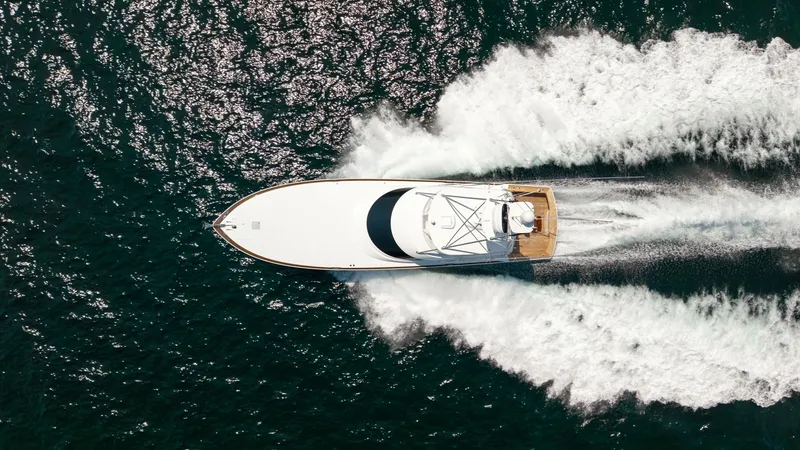 Slide: The Image of Aerial View of Viking 74 Convertible This aerial image showcases the sleek design and powerful performance of the 2025 Viking 74 Convertible, 'It Just Takes Time.' The vessel cuts through the water with precision, leaving a dynamic wake behind. The spacious aft deck is clearly visible, desig - 7531212