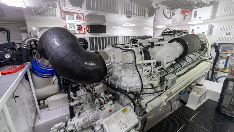 Slide: The Image of Engine Room with Dual Engines The engine room of the 2025 Viking 74 Convertible showcases powerful dual engines, designed for optimal performance and efficiency. The space is meticulously organized, with a clean, well-lit environment that highlights the advanced engineering and robust - 7531185