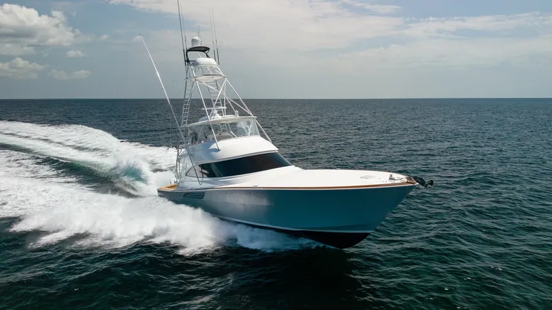 Slide: The Image of Dynamic Bow View in Motion The Viking 74 Convertible 'It Just Takes Time' showcases its sleek bow slicing through the water with effortless grace. The hull's sharp lines and aerodynamic design are highlighted as it navigates the open sea, emphasizing the vessel's speed and agility. - 7531211