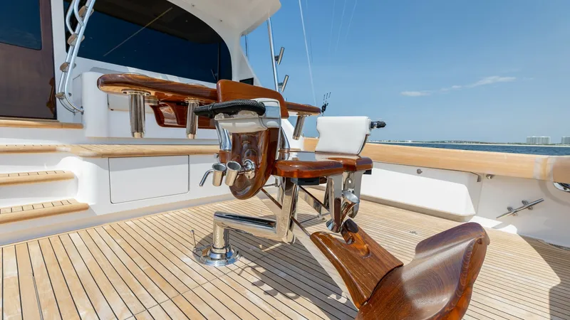 Slide: The Image of Aft Deck with Fighting Chair The aft deck of the 2025 Viking 74 Convertible features a high-quality teak floor and a robust fighting chair, perfect for sport fishing enthusiasts. The polished finish of the chair and the ample cockpit space provide both functionality and comfort. This - 7531190