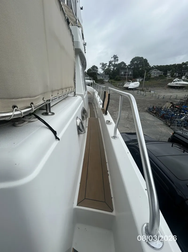 Slide: The Image of 43' Mainship starboard side deck2 - 7407586