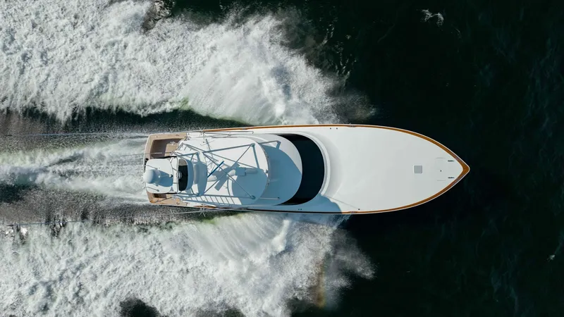 Slide: The Image of Aerial View of Viking 72 Bow This stunning aerial shot captures the sleek bow of the 2018 Viking 72 Convertible, slicing through the water with ease. The vessel's dynamic design is highlighted by the clean lines and aerodynamic form, emphasizing its powerful performance. The wake tra - 7460631