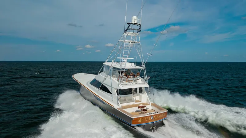 Slide: The Image of Aerial Aft View with Tower The 2018 Viking 72 Convertible 'Metal Masher' showcases its powerful design from an aerial aft perspective, emphasizing the expansive cockpit and sleek tower. The yacht's dynamic stance on the open sea highlights its superior performance and craftsmanship - 7460630