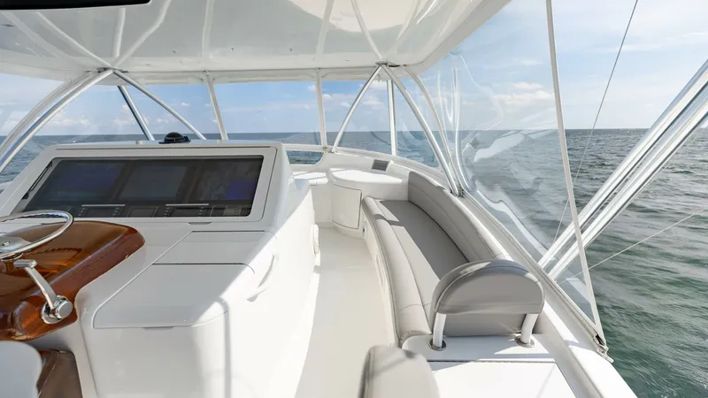 Slide: The Image of Flybridge Helm with Seating Area The flybridge of the 2018 Viking 72 Convertible features a sophisticated helm station with state-of-the-art navigation equipment. The area is complemented by plush, wrap-around seating, offering panoramic views of the ocean. The spacious layout and premiu - 7460618