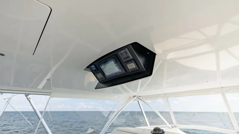 Slide: The Image of Flybridge Electronics Console This image showcases the sleek electronics console on the flybridge of the 2018 Viking 72 Convertible. The integrated multi-function display offers advanced navigation and control features, ensuring a state-of-the-art piloting experience. The expansive vi - 7460613