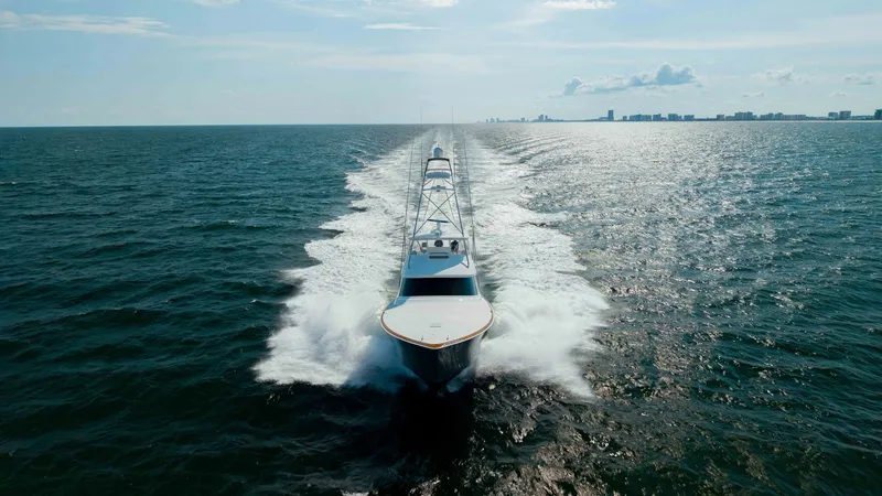 Slide: The Image of Aerial View of Bow Underway The Viking 72 Convertible, Metal Masher, cuts through the open water with impressive agility. The aerial perspective showcases the sleek bow design and powerful wake, emphasizing its robust performance and engineering. The expansive ocean backdrop highlig - 7460629