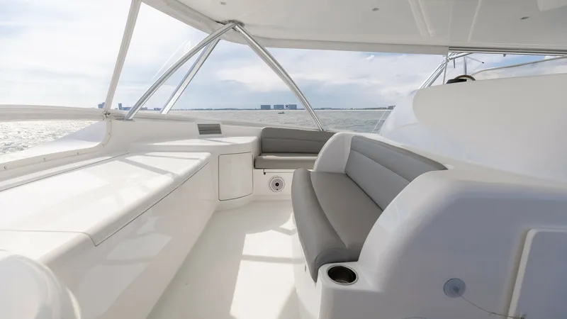 Slide: The Image of Flybridge Seating Area with Ocean View Experience the expansive flybridge of the 2018 Viking 72 Convertible, featuring sleek seating arrangements with plush upholstery. The area is designed for comfort and style, offering panoramic views of the ocean, perfect for relaxation or entertaining. Th - 7460616