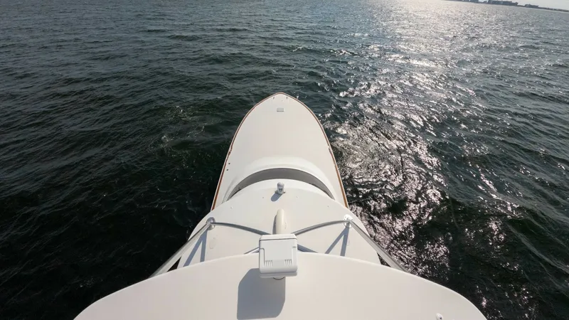 Slide: The Image of Bow View Overlooking Open Water Experience the expansive views from the bow of the 2018 Viking 72 Convertible, Metal Masher. The sleek design offers a commanding perspective over the shimmering ocean, emphasizing the vessel's superior craftsmanship. Ideal for navigation and leisure, thi - 7460621