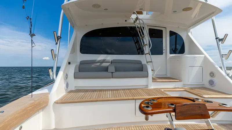 Slide: The Image of Spacious Aft Deck with Seating The aft deck of the 2018 Viking 72 Convertible features a generous seating area with plush cushions, perfect for relaxation and entertaining. The teak flooring adds a touch of elegance and durability, while the open layout provides seamless access to the - 7460603
