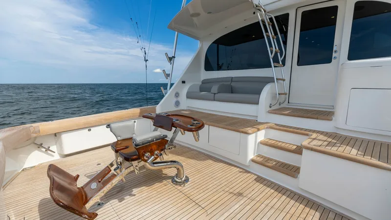 Slide: The Image of Aft Deck with Fishing Chair The aft deck of the 2018 Viking 72 Convertible showcases a professional-grade fishing chair, perfect for deep-sea angling. The spacious teak deck offers ample room for movement, while the built-in seating provides a relaxing spot for guests. This area is - 7460604