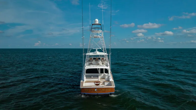 Slide: The Image of Aft View with Tower and Cockpit This image showcases the aft view of the 2018 Viking 72 Convertible, highlighting its spacious cockpit and impressive tower. The open deck provides ample space for fishing or relaxing, while the sleek tower offers excellent visibility for navigating or sp - 7460627