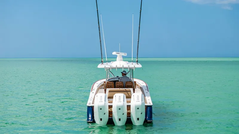 Slide: The Image of Aft View with Triple Outboard Engines This image showcases the sleek aft view of the 2024 Valhalla V-37, featuring three powerful outboard engines designed for optimal performance. The spacious deck provides ample seating, perfect for both relaxation and entertaining. The pristine waters high - 7471225