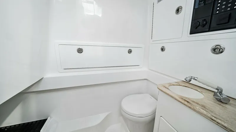 Slide: The Image of Compact Marine Head The V-37 features a sleek and functional marine head, designed for optimal space utilization. The bright white finish and stainless steel fixtures provide a clean and modern look, while the integrated cabinetry offers ample storage. Ideal for extended tri - 7471185