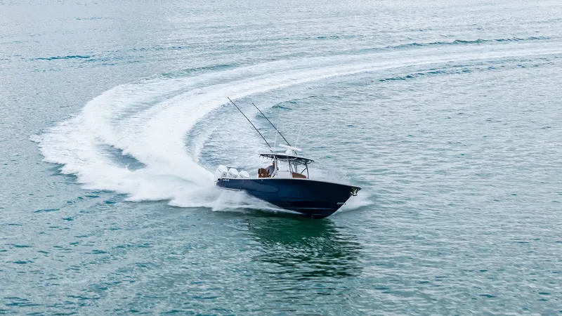 Slide: The Image of Dynamic Aerial View of V-37 This stunning aerial shot captures the Valhalla V-37 cutting gracefully through the water, showcasing its sleek hull and powerful performance. The vessel's elegant design is highlighted by the smooth wake trailing behind, emphasizing its agility and speed - 7471246