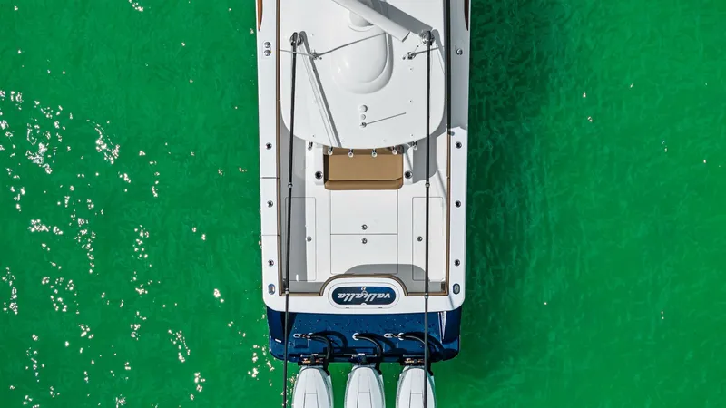Slide: The Image of Aerial View of Stern and Engines This overhead shot of the 2024 Valhalla Boatworks V-37 showcases the efficient and sleek design of its stern. Equipped with three powerful outboard engines, the vessel promises exceptional performance and speed. The spacious aft deck is perfect for fishin - 7471220