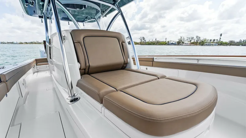 Slide: The Image of Bow Lounge Seating Area The V-37 by Valhalla Boatworks features a luxurious bow lounge with plush, tan cushions for ultimate comfort while cruising. The sleek design integrates seamlessly into the deck, offering a perfect spot for relaxation with panoramic views of the surroundi - 7471196