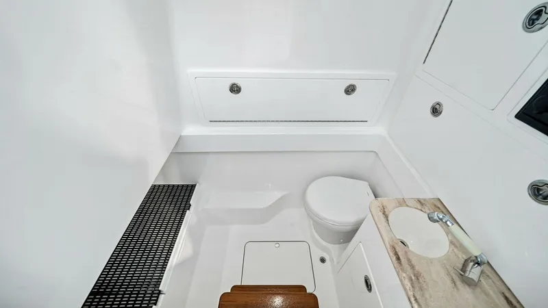 Slide: The Image of Compact Onboard Head This sleek onboard head from the 2024 Valhalla Boatworks V-37 features a streamlined design with high-gloss white finishes. A compact toilet and a practical sink with a marble countertop provide essential amenities, while integrated storage ensures functi - 7471184