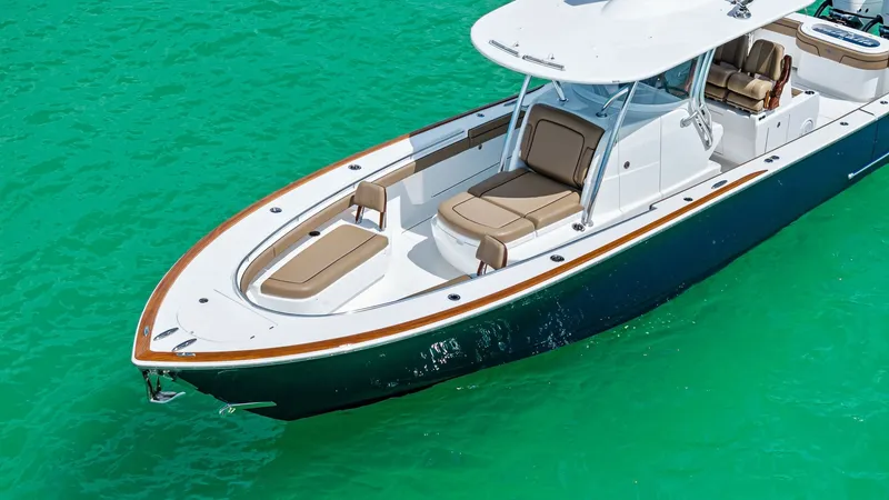Slide: The Image of Bow Area with Sun Pads The bow of the Valhalla V-37 'BIRD' features inviting sun pads with elegant tan upholstery, perfect for relaxation. The sleek design is accentuated by a polished white hull and a robust T-top for shade. Ideal for both leisure and functional use, this area - 7471221