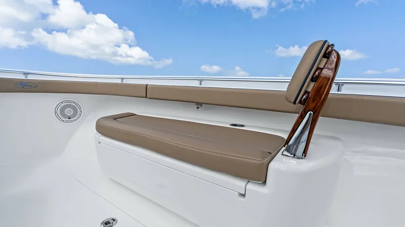 Slide: The Image of Forward Seating and Backrest The forward seating area on the 2024 Valhalla Boatworks V-37 features a plush, tan cushion with a stylish wooden backrest, offering comfort and elegance. The clean white deck contrasts beautifully with the seating, while integrated speakers ensure a rich - 7471187