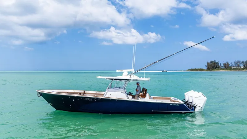 Slide: The Image of Side Profile of Valhalla V-37 This image showcases the sleek side profile of the 2024 Valhalla V-37 by Valhalla Boatworks. The deep blue hull contrasts beautifully with the turquoise water, highlighting the boat's elegant lines and modern design. Equipped with powerful outboard engine - 7471229