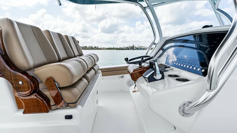 Slide: The Image of Helm Station with Seating This image showcases the helm station of the 2024 Valhalla Boatworks V-37, featuring a sleek console with state-of-the-art controls and instrumentation. The comfortable, upholstered seating offers ergonomic support, complemented by high-quality wood accen - 7471213