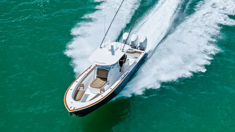 Slide: The Image of Aerial View of Bow and Cockpit This dynamic aerial shot showcases the sleek design of the 2024 Valhalla V-37 by Valhalla Boatworks. The vessel 'BIRD' is captured gliding effortlessly through the water, highlighting its powerful twin engines and streamlined hull. The spacious bow area o - 7471243