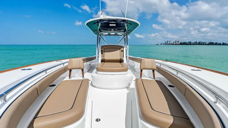Slide: The Image of Spacious Bow Seating Area The 2024 Valhalla Boatworks V-37 showcases a luxurious bow seating area with plush, tan upholstery. This inviting space is perfect for relaxation while cruising, offering ample seating and a sun pad, ideal for enjoying panoramic ocean views. The sleek des - 7471199