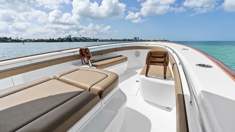 Slide: The Image of Spacious Forward Seating Area The V-37 by Valhalla Boatworks features a luxurious forward seating area with plush, tan upholstery. Ample seating is complemented by elegant teak accents, providing a perfect spot for relaxation while enjoying panoramic ocean views. The sleek design and - 7471195