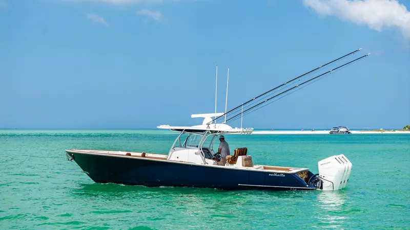 Slide: The Image of Side View of Valhalla V-37 The 2024 Valhalla V-37 is showcased in a vibrant marine setting, highlighting its sleek hull and powerful outboard motors. The vessel's elegant lines and spacious deck offer a perfect mix of performance and comfort, ideal for both fishing and leisure. Its - 7471226