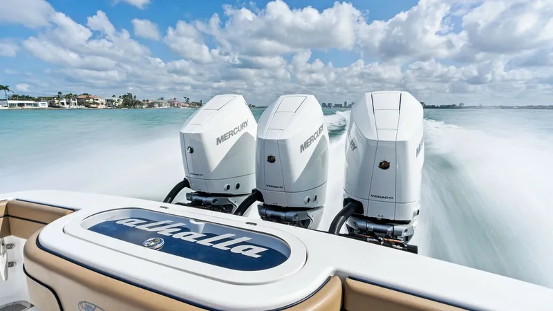 Slide: The Image of Triple Outboard Engines in Action The 2024 Valhalla V-37 showcases its impressive performance with three powerful Mercury outboard engines, propelling the vessel effortlessly across the water. The sleek design and robust power of these engines ensure a thrilling and efficient ride. This s - 7471177