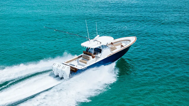 Slide: The Image of Aerial View of V-37 in Motion The 2024 Valhalla V-37, named 'BIRD', showcases its sleek design and powerful performance on open waters. This dynamic aerial shot captures the vessel's triple outboard engines propelling it effortlessly, while the streamlined hull slices through the sea. - 7471239