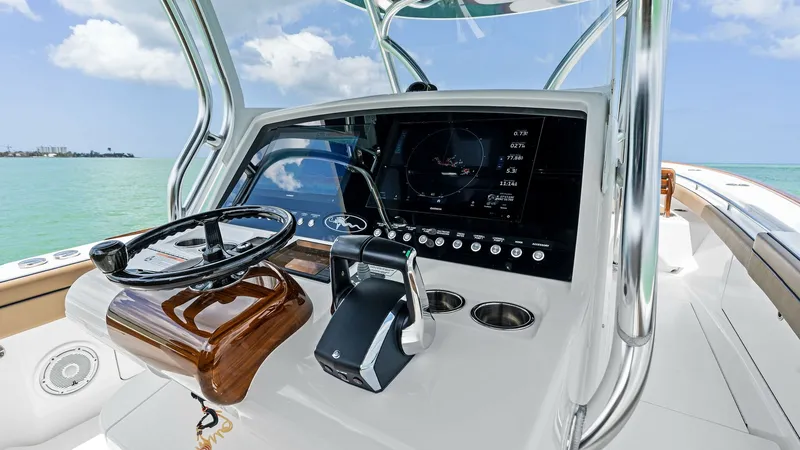 Slide: The Image of Helm Station with Electronics Display The helm of the 2024 Valhalla Boatworks V-37 showcases a sleek, modern design with a state-of-the-art electronics display. The polished wood steering wheel and ergonomic controls ensure a comfortable and intuitive navigation experience. Stainless steel ac - 7471204