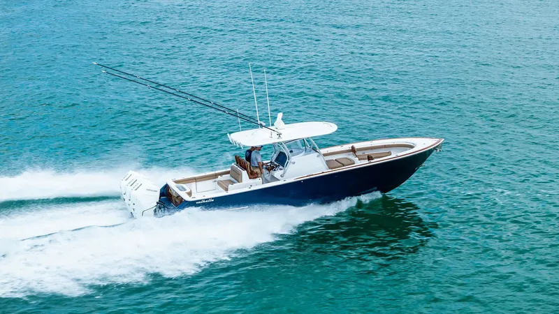 Slide: The Image of Dynamic Aerial View of V-37 This image showcases the 2024 Valhalla Boatworks V-37 gliding effortlessly across the water. The sleek hull design and powerful outboard engines emphasize speed and agility, making it perfect for offshore adventures. The spacious deck and modern helm stat - 7471240