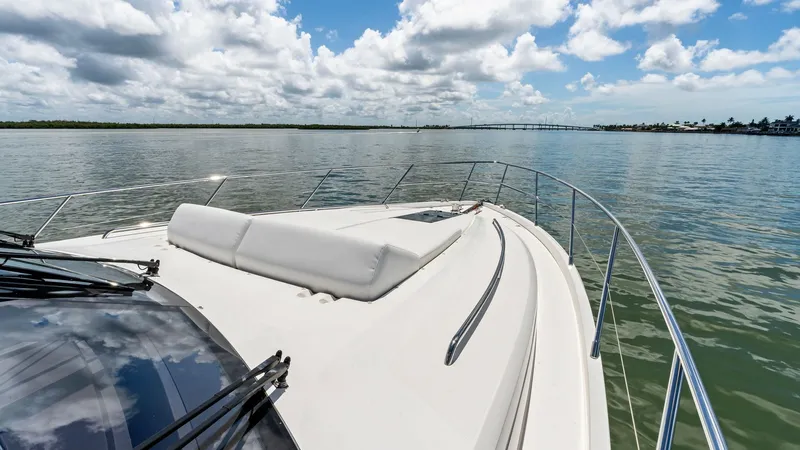 Slide: The Image of Forward Deck with Sunpad Lounge The forward deck of the 2016 Princess 64 Flybridge features a spacious sunpad lounge, perfect for soaking up the sun while cruising. The sleek stainless steel railings provide safety and style, complementing the yacht's elegant design. Enjoy panoramic wat - 7460863