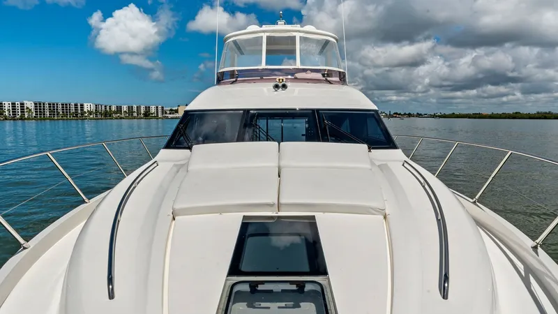 Slide: The Image of Bow View with Flybridge This image showcases the sleek bow design of the 2016 Princess 64 Flybridge. The expansive foredeck features clean lines and integrated handrails, offering both style and safety. The flybridge above provides a commanding vantage point, perfect for taking - 7460866
