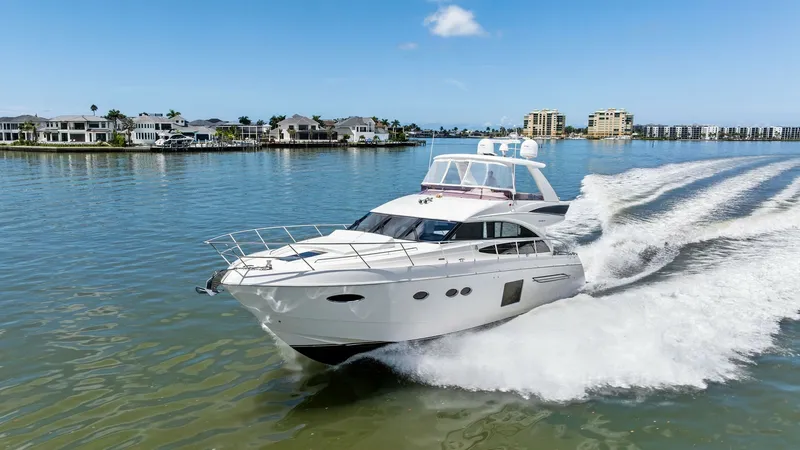 Slide: The Image of Dynamic Bow View Underway The 2016 Princess 64 Flybridge 'No Vacansea' cuts gracefully through the water, showcasing its sleek hull design and elegant lines. The flybridge offers an expansive view, while the bow is equipped with stainless steel railings for safety and style. This - 7460889